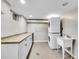 Well-appointed laundry room equipped with washer, dryer, utility sink, and ample storage at 240 Colorado Blvd, Denver, CO 80206