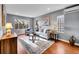 Cozy living room featuring hardwood floors, neutral furniture, and ample natural light at 240 Colorado Blvd, Denver, CO 80206