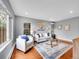 Bright living room with hardwood floors, a neutral color scheme, and large windows at 240 Colorado Blvd, Denver, CO 80206