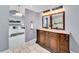Main bathroom vanity has double sinks, updated lighting, and seamless access to the main bedroom at 240 Colorado Blvd, Denver, CO 80206