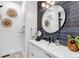 Modern bathroom with a black faucet, round mirror, and stylish blue tile backsplash at 202 October Pl, Castle Rock, CO 80104