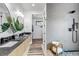Contemporary bathroom featuring double sinks, stylish wall tiles, and a sleek, modern shower at 202 October Pl, Castle Rock, CO 80104