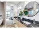 Bright bathroom showcasing double sinks, circular mirrors, and an open doorway to the bedroom and closet at 202 October Pl, Castle Rock, CO 80104