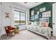 Bright bedroom with a scenic view, showcasing a cozy daybed and unique decorative accents at 202 October Pl, Castle Rock, CO 80104