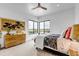 Bright bedroom with a wooden dresser, modern ceiling fan, and corner windows offering scenic views at 202 October Pl, Castle Rock, CO 80104