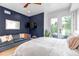 Comfortable bedroom with a blue accent wall, a plush sofa, and balcony access with outdoor seating at 202 October Pl, Castle Rock, CO 80104