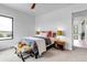 Bright bedroom with a stylish floral bedspread, carpeted floor, and large window with picturesque views at 202 October Pl, Castle Rock, CO 80104