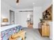 Bright bedroom featuring a sliding barn door leading to the bathroom and walk-in closet at 202 October Pl, Castle Rock, CO 80104