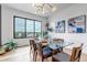 Elegant dining area features a modern chandelier, artwork, and panoramic views from the window at 202 October Pl, Castle Rock, CO 80104
