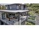 Modern home with outdoor deck, dining furniture, and hillside views at 202 October Pl, Castle Rock, CO 80104