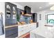 Modern kitchen with contrasting cabinetry, butcher block countertops, and a black range hood at 202 October Pl, Castle Rock, CO 80104