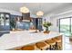 Charming kitchen island with a white countertop and lots of counter seating at 202 October Pl, Castle Rock, CO 80104