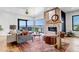 Bright living room featuring a stone fireplace, hardwood floors, and stunning views at 202 October Pl, Castle Rock, CO 80104