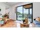 Bright living room featuring terracotta tile floor and large windows with an outdoor view at 202 October Pl, Castle Rock, CO 80104