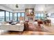 Open-concept living room with stone fireplace, hardwood floors, and ample natural light at 202 October Pl, Castle Rock, CO 80104