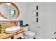 Stylish powder room features a round mirror, unique tile accents, and a modern vessel sink at 202 October Pl, Castle Rock, CO 80104
