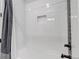 Bright shower with white tiling, built-in shelf, and modern fixtures at 202 October Pl, Castle Rock, CO 80104