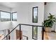 Contemporary staircase design with sleek railing and plenty of natural light from multiple windows at 202 October Pl, Castle Rock, CO 80104