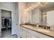 Double vanity bathroom with a large mirror and shower at 6942 Huddersfield Ln, Castle Pines, CO 80108