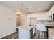 Modern kitchen with white cabinets, island, and stainless steel appliances at 6942 Huddersfield Ln, Castle Pines, CO 80108