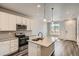 Spacious kitchen with white cabinets, island, stainless steel appliances, and a view at 6942 Huddersfield Ln, Castle Pines, CO 80108