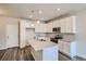 Open concept kitchen with white cabinets, an island, and stainless steel appliances at 6942 Huddersfield Ln, Castle Pines, CO 80108