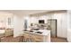 Modern kitchen with white cabinetry, stainless appliances, eat-in island and open concept layout at 22361 E 38Th Pl, Aurora, CO 80019