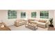 Cozy living room with neutral decor, plush seating, and large windows for natural light at 22361 E 38Th Pl, Aurora, CO 80019
