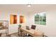 Bright office space with large window, modern desk, brown leather chair, and decorative wall art at 22361 E 38Th Pl, Aurora, CO 80019