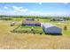 Aerial view of a property featuring a home, a large workshop, and a fenced garden area on a spacious lot at 177 W 8Th Ave, Byers, CO 80103