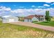 Aerial view of a home with a large yard, additional garages, and scenic surroundings at 177 W 8Th Ave, Byers, CO 80103