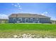 Large backyard with a well-maintained lawn and a view of the home's exterior at 177 W 8Th Ave, Byers, CO 80103