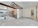 Unfinished basement featuring open storage area, utilities, and concrete floor at 177 W 8Th Ave, Byers, CO 80103