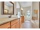 Bathroom featuring dual vanities, a soaking tub, and tiled floors at 177 W 8Th Ave, Byers, CO 80103