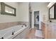 Bathroom featuring a soaking tub, step-in shower, and a marble countertop vanity at 177 W 8Th Ave, Byers, CO 80103