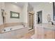 Bathroom featuring a soaking tub, step-in shower, and a marble countertop vanity at 177 W 8Th Ave, Byers, CO 80103
