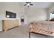 Bedroom featuring a ceiling fan, and a door leading into the home's living space at 177 W 8Th Ave, Byers, CO 80103