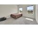 Bedroom with neutral walls, carpet, and windows offering outside views at 177 W 8Th Ave, Byers, CO 80103