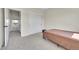 Bedroom featuring neutral walls, carpet, closet with sliding doors, and an open doorway at 177 W 8Th Ave, Byers, CO 80103