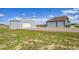 Home exterior with a two-car garage, an additional garage, and green lawn at 177 W 8Th Ave, Byers, CO 80103