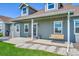 Inviting front porch with swing, potted plants, and stone accents at 177 W 8Th Ave, Byers, CO 80103