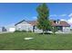 Charming single-story home with a large, lush front yard and a detached garage at 177 W 8Th Ave, Byers, CO 80103