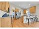 Modern kitchen with stainless steel appliances, wood cabinets, and breakfast bar at 177 W 8Th Ave, Byers, CO 80103