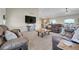 Open concept living room with vaulted ceilings, modern furnishings, and backyard access at 177 W 8Th Ave, Byers, CO 80103