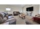 Cozy living room with vaulted ceilings, plush carpeting, and stylish decor at 177 W 8Th Ave, Byers, CO 80103