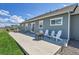 Back patio with a grill, outdoor seating, and a view of the well-maintained yard at 177 W 8Th Ave, Byers, CO 80103