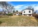 Spacious backyard with a fire pit, lush lawn, and a white two-story home at 1565 S Helena Cir, Aurora, CO 80017