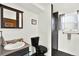 Modern bathroom with a sleek vanity, black toilet, and a glass-enclosed shower, plus natural lighting at 1565 S Helena Cir, Aurora, CO 80017
