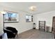 Bright bedroom with natural light, featuring sleek wood floors, a comfortable chair, and minimalist decor at 1565 S Helena Cir, Aurora, CO 80017