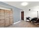 Cozy bedroom with a screen, comfortable chair, wood-style floors, and ample space for relaxation at 1565 S Helena Cir, Aurora, CO 80017